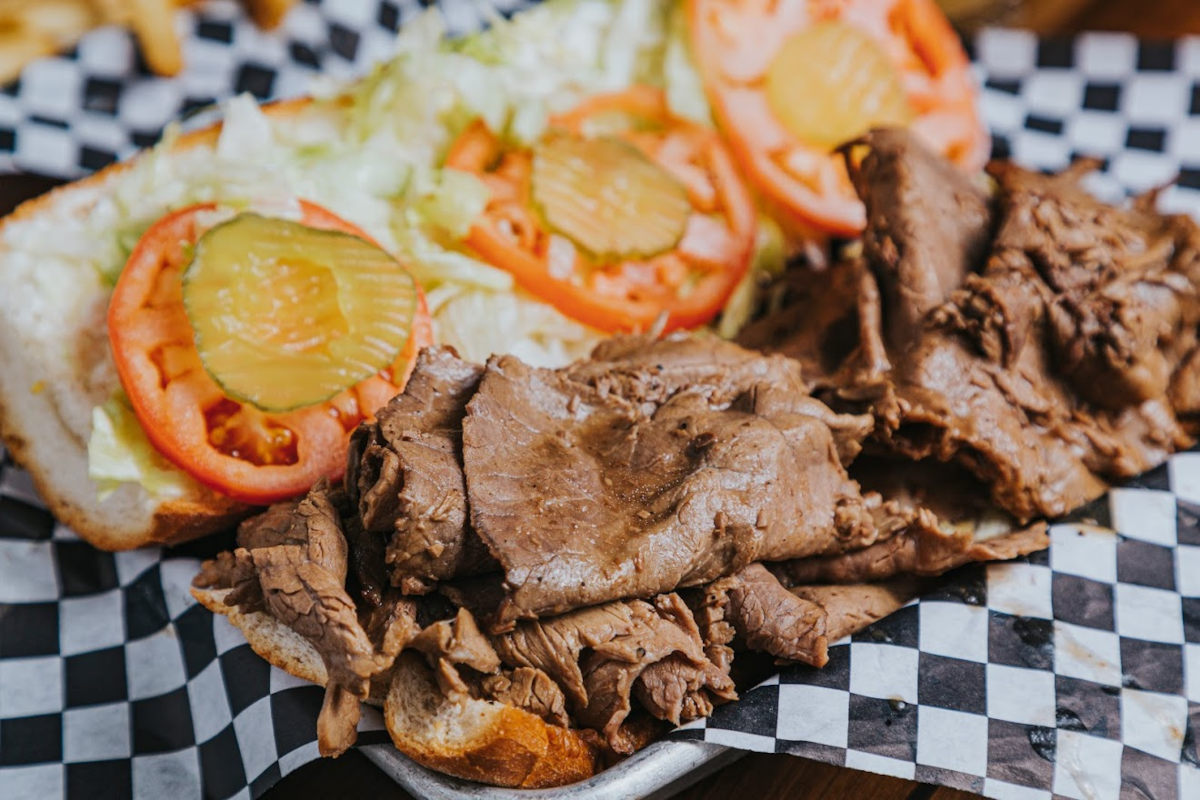 Sandwich with grilled sliced meat and salad